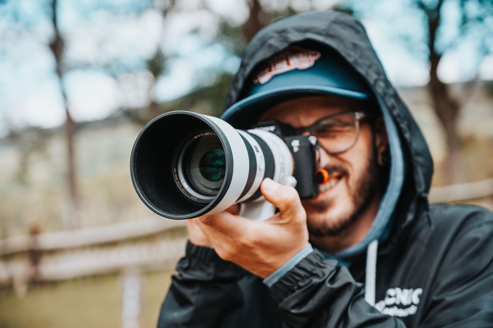 Photographer holding a camera with a prime lens
